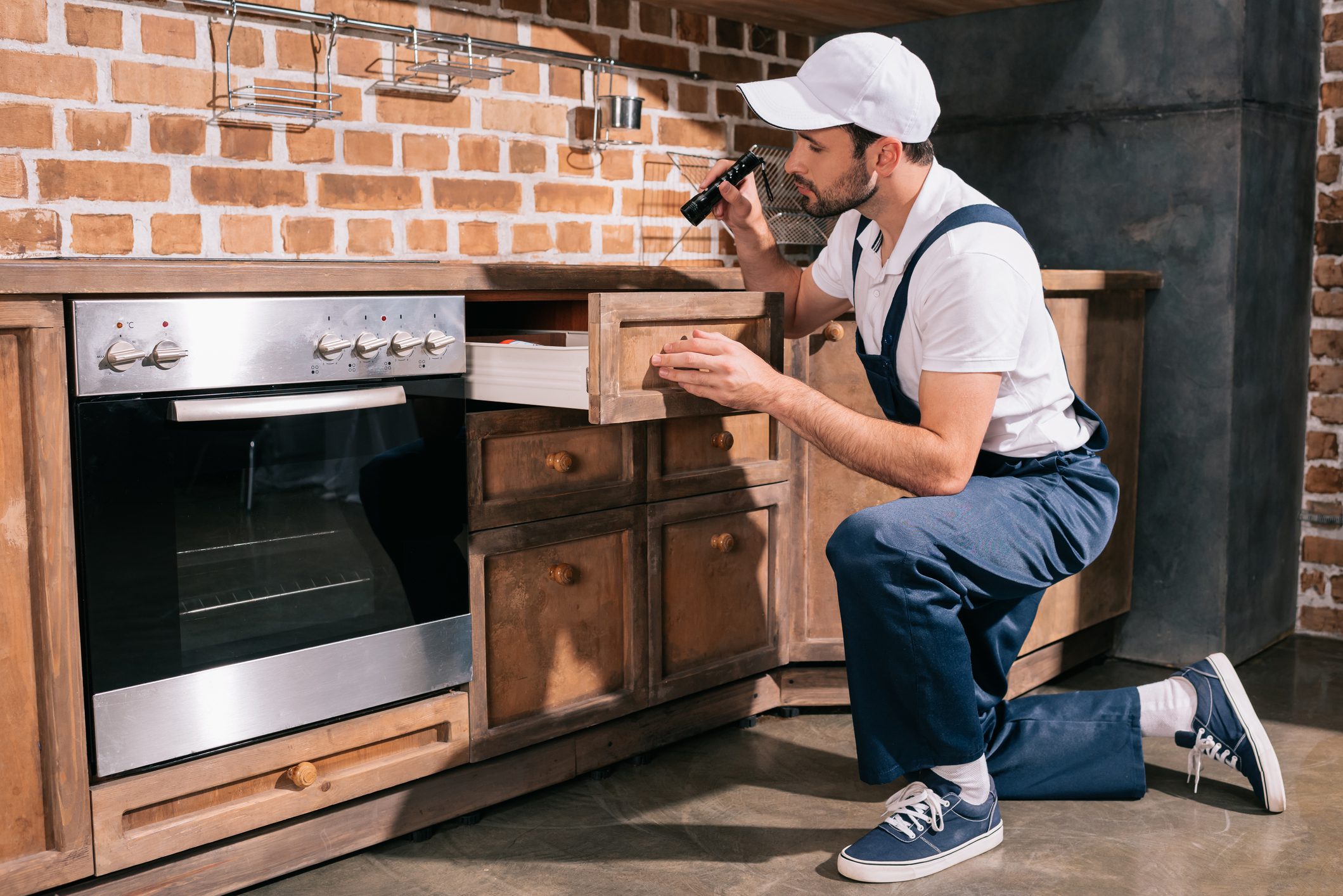 Technician checking under counter space